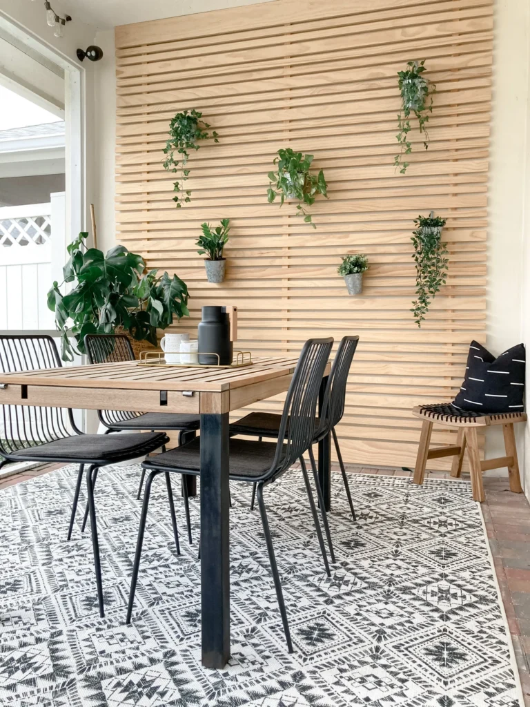 IKEA ÄPPLARÖ patio table revamped with a natural wood finish and black painted legs.
