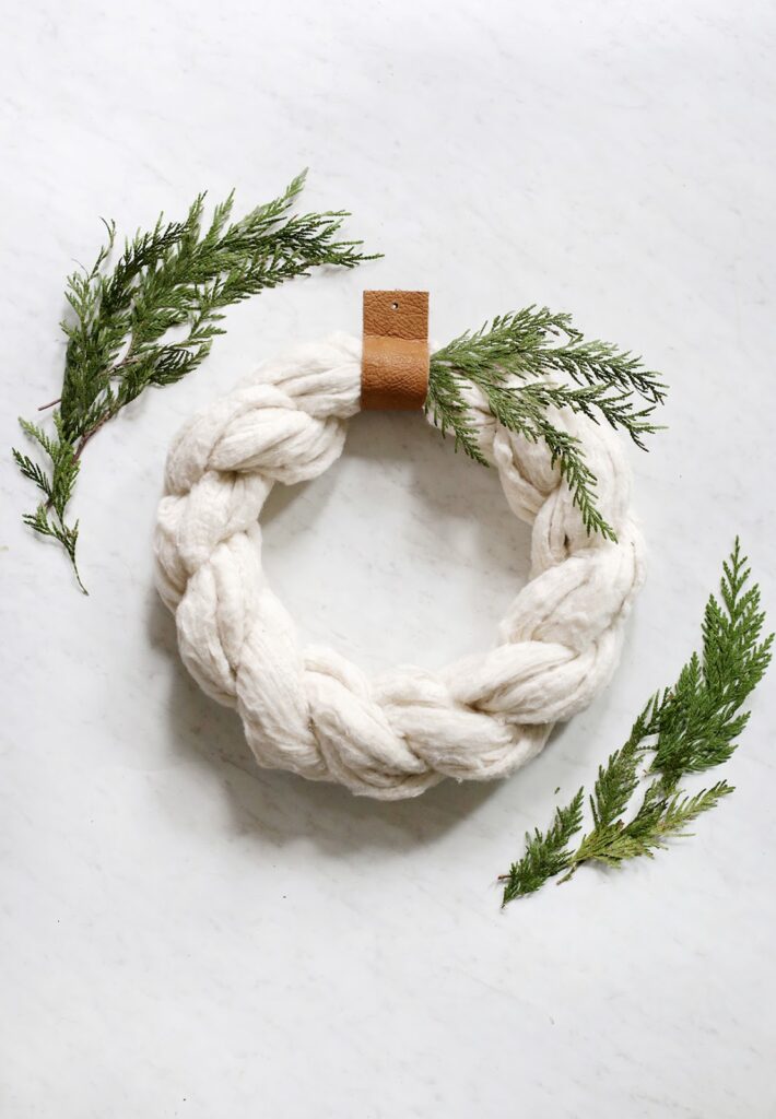 A serene DIY Christmas wreath crafted with fluffy cotton balls.