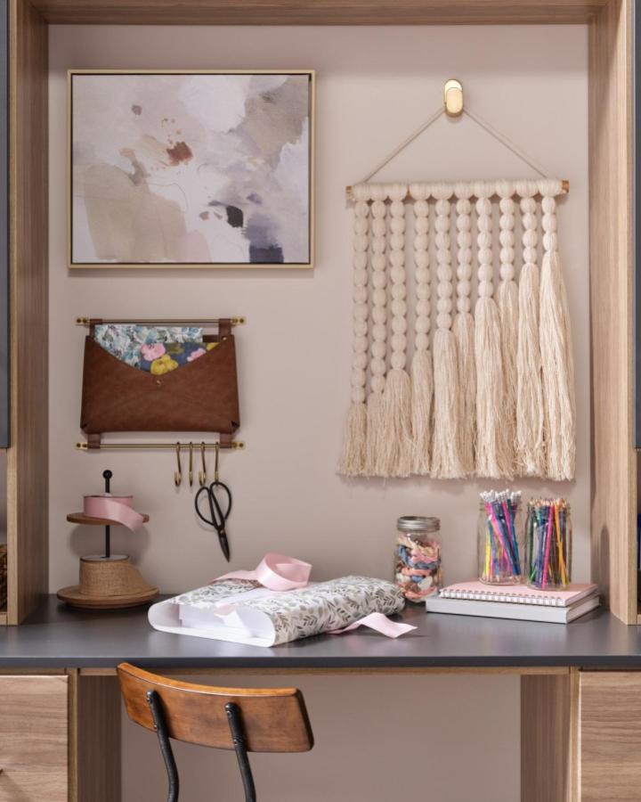 Brown leather organizer pocket from @inspiredclosetsva. Wall-mounted storage solution with brass hardware and hanging hooks.