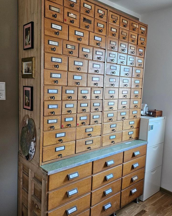 Vintage oak card catalog storage system from @luiseheinzl showcasing dream craft room inspiration with organized drawers.