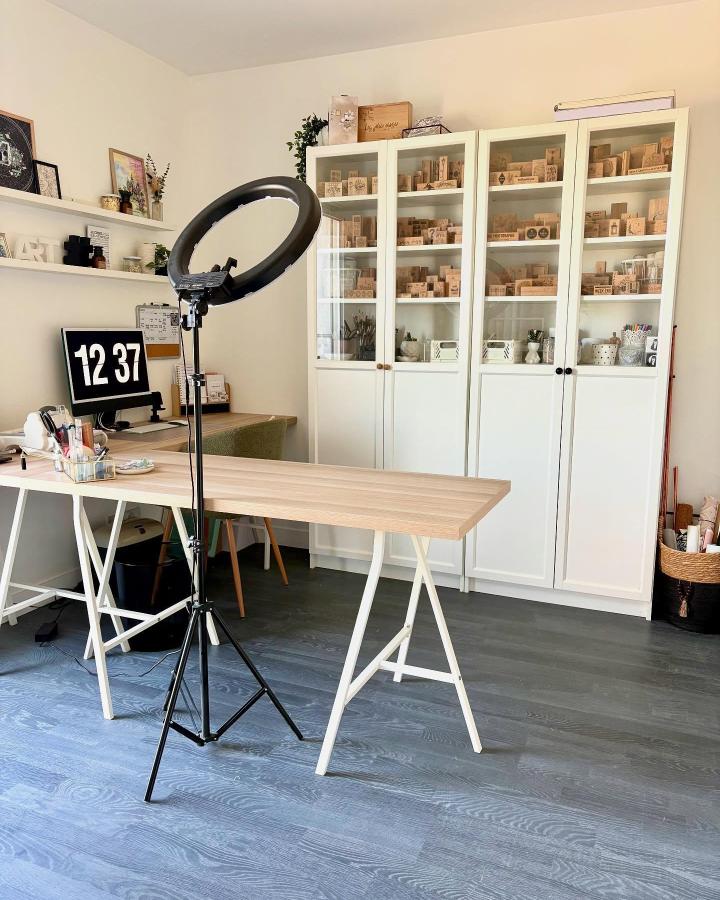 Organized white glass cabinets from @maylis.astier. Professional craft storage with wooden shelves and matching containers.