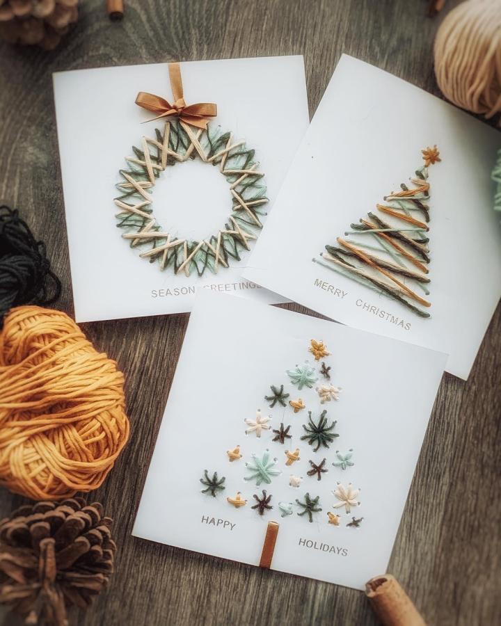 Embroidered paper christmas crafts for adults from @nimbo.m featuring wreath, tree, and snowflake card designs with copper ribbon accents