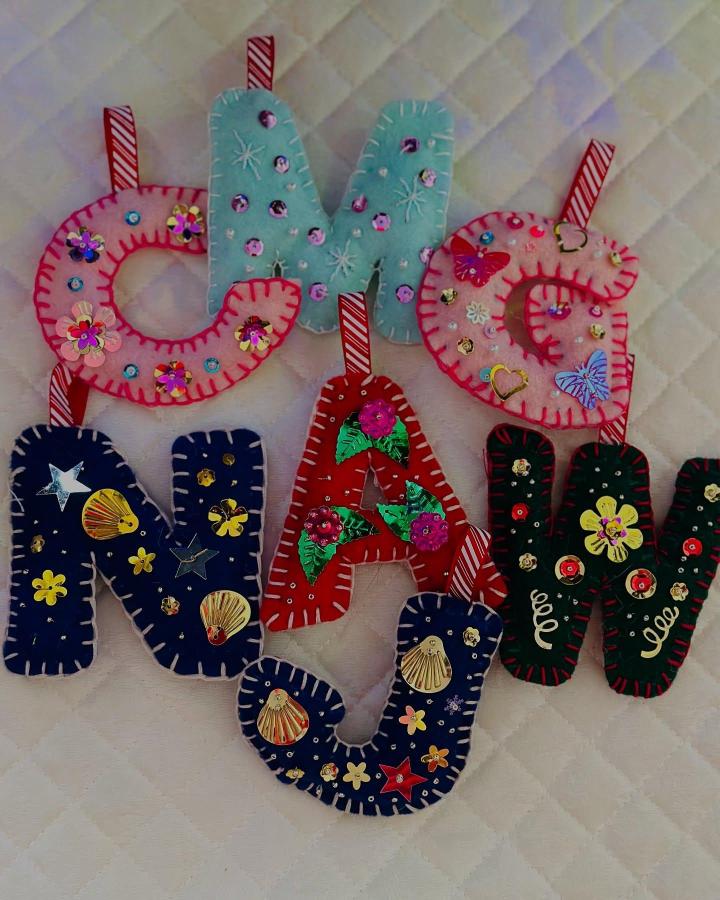 Colorful embellished felt letter ornaments from @c_crafty_ with sequins and blanket stitch edging