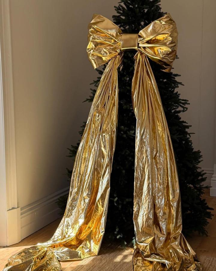 Oversized metallic gold bow topper from @neueblvd. Reflective material catches natural light beautifully.