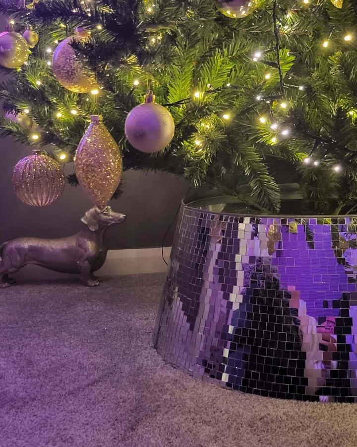 Purple mirrored mosaic tree skirt from @glam.globes, christmas tree skirt ideas with reflective tiles and holiday decor.