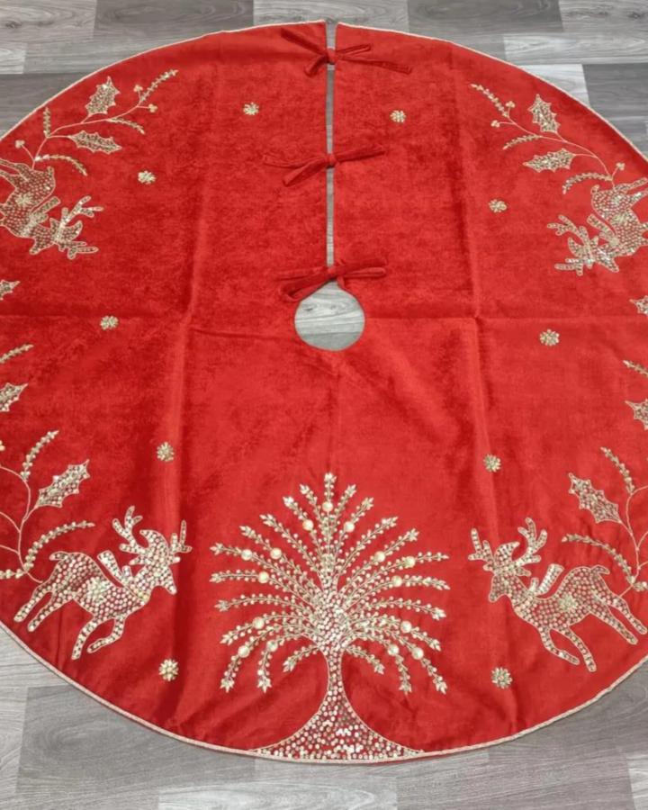 Red velvet tree skirt from Craftcafeindia featuring beaded reindeer and nature motifs in champagne tones.