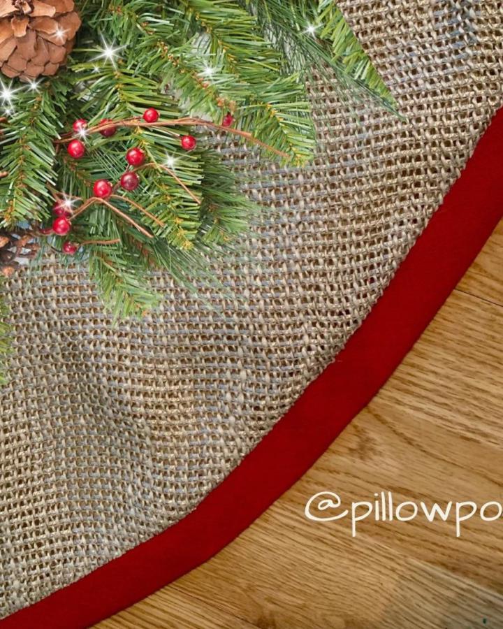 Natural burlap christmas tree skirt ideas from pillowpods featuring red trim and rustic holiday texture.