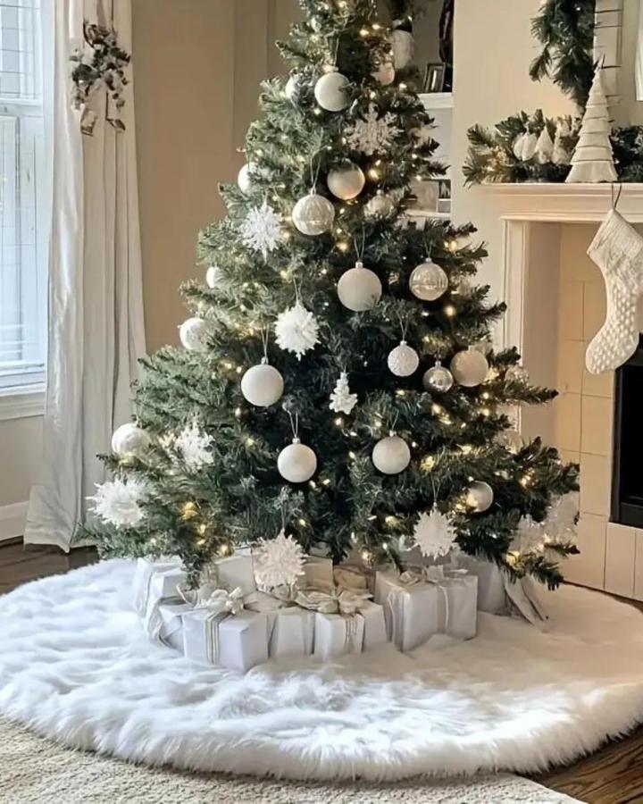 White faux fur tree skirt from ArtisanStoriesCo enhancing neutral holiday display with wrapped presents