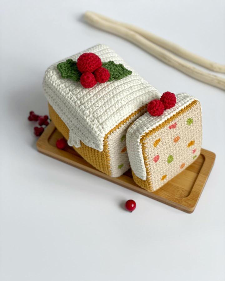 Cream and golden crocheted yule log from @marybrowncraft showcasing crochet christmas decorations ideas with berry topper.
