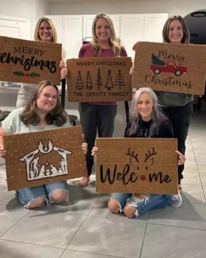 Personalized coir doormats from @rebeccanahra featuring girls night christmas crafts with painted holiday designs and festive greetings.