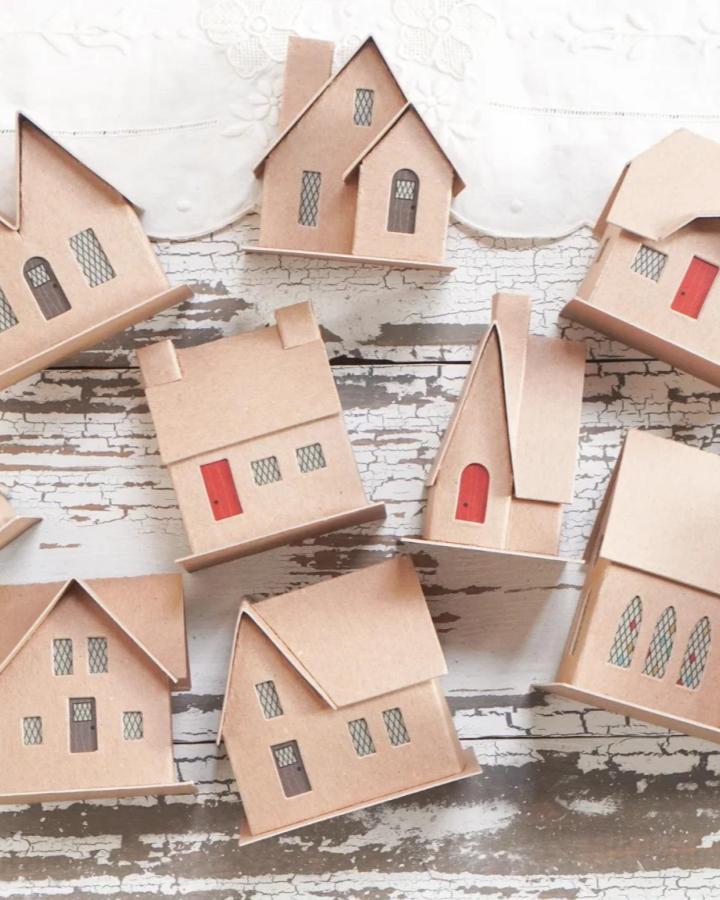 Kraft cardboard miniature houses from @smilemercantile perfect for girls night christmas crafts with red door accents