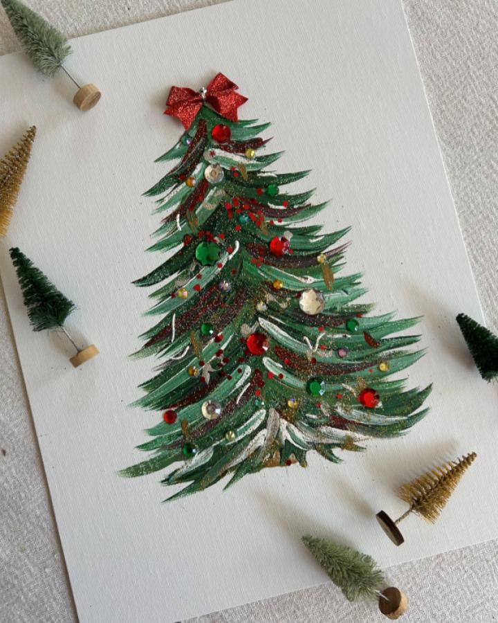 Glittery green handprint tree craft from @ek_graphic_ with red bow and ornament details
