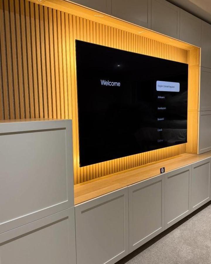 Backlit wood slat ikea media center hacks & ideas from @theflatpackmanni. Grey Besta cabinets with integrated LED lighting.