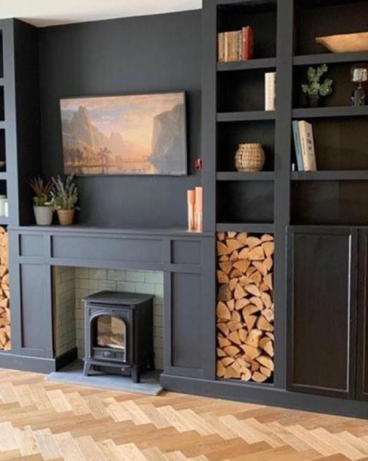 Charcoal gray Billy bookcase fireplace wall from @fixupjaynesharp with firewood storage and herringbone flooring.