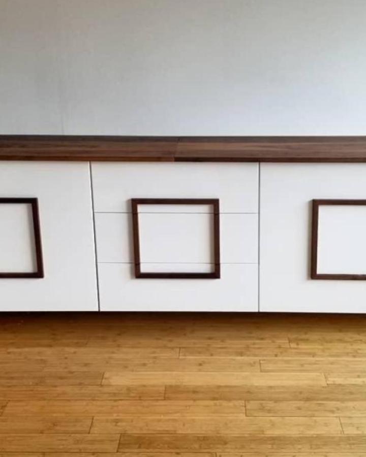 White media console from @livingstoncabinetry with walnut frame accents and countertop.
