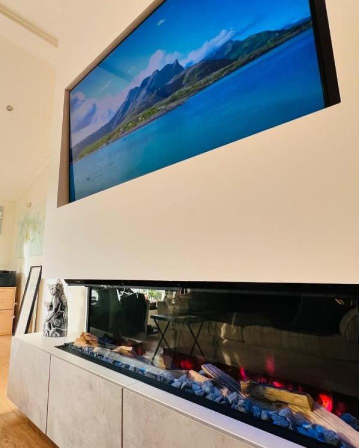 White media console featuring ikea media center hacks & ideas from @cmaelectrical with built-in electric fireplace and decorative stones.