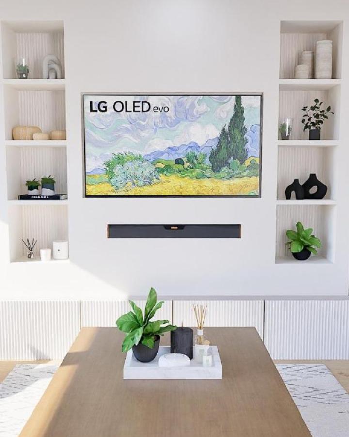 White built-in media wall showcasing ikea media center hacks & ideas from @e2design_interiors with textured shelving niches.