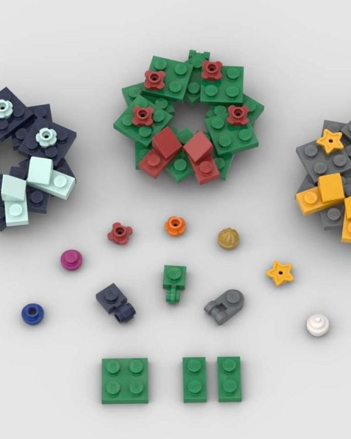 Green brick wreath ornament from Rebrickable featuring red flowers and coral bow pieces