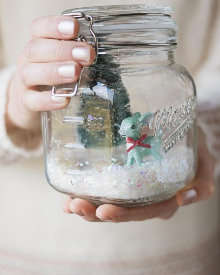 Clear glass jar with miniature winter scene from @bellewoodcottage featuring glittery deer and bottle brush tree