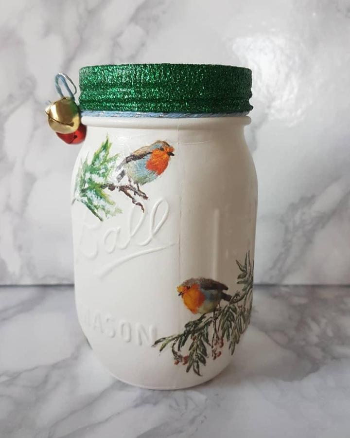 White decoupage jar featuring robin imagery, ideal for mason jar christmas crafts from @flutterbybespokegifts. Emerald glitter ribbon detail.