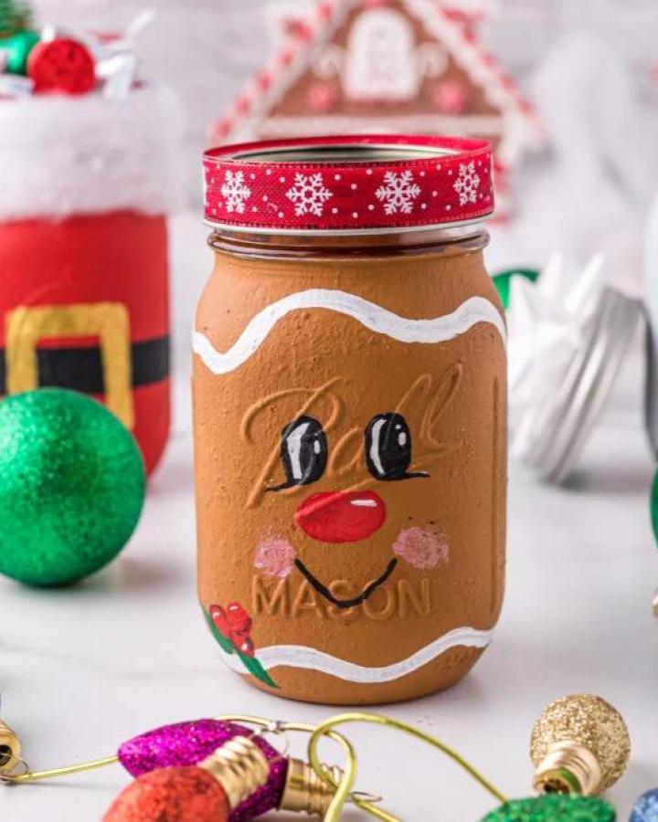 Brown painted gingerbread character jar from Hip Mamas Place with festive ribbon and hand-painted facial features.