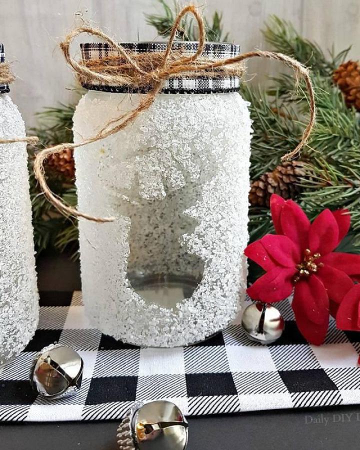 White glitter snowflake lantern from @dailydiylife with buffalo check ribbon and twine handle.