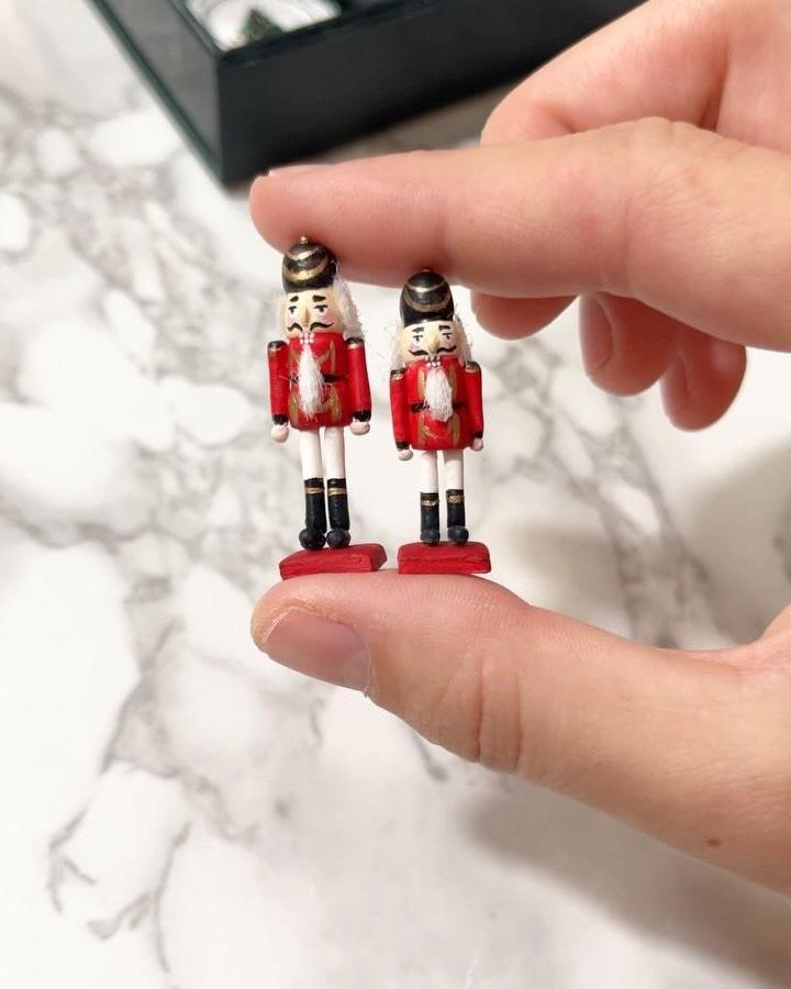 Hand-painted red nutcracker soldiers from @ystreetstudio. Traditional holiday figurines with black and white details.