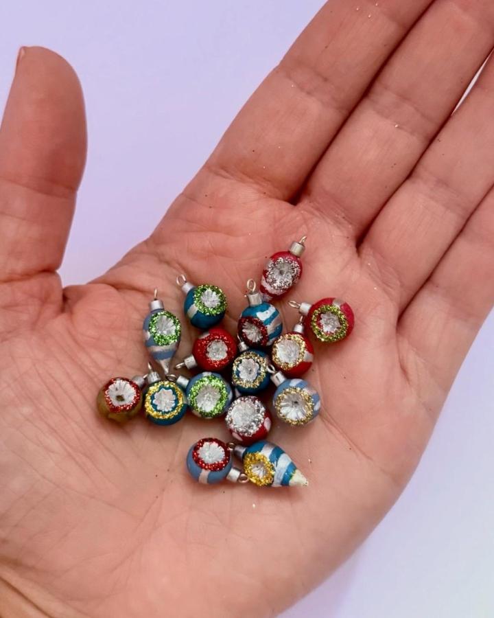 Colorful vintage-style glass ornament charms from @letties.dollhouse with metallic trim and striped patterns