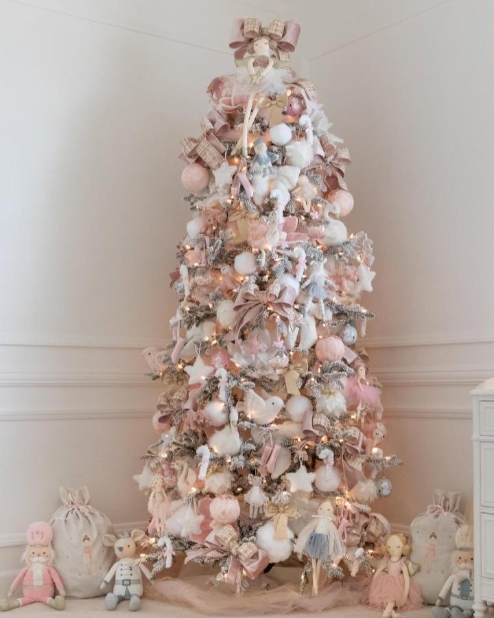 Blush and white flocked tree with gingham bows from @homedesignbychristinamarie showcasing pink christmas tree ideas with plush figures.
