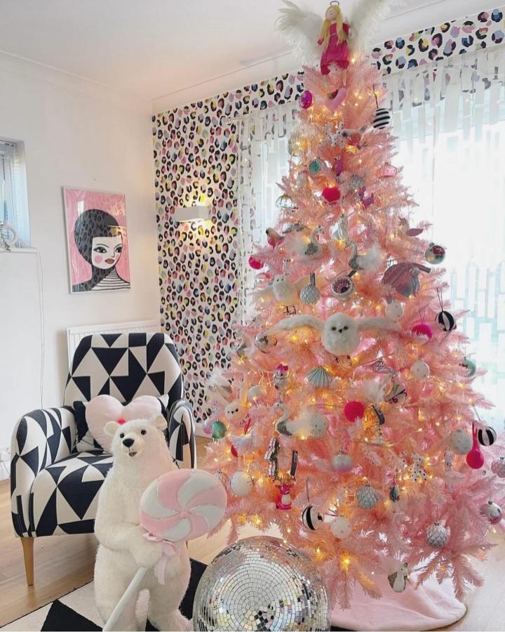 Blush pink tree with pink christmas tree ideas from @colourpopathome featuring disco ball and leopard print wallpaper backdrop.