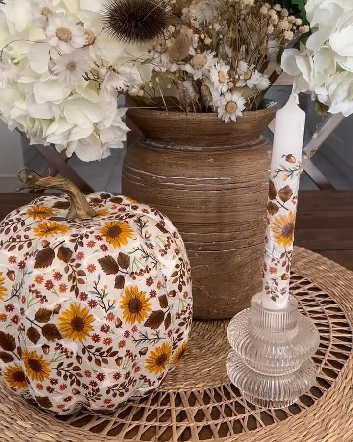 Sunflower-patterned fabric pumpkin from @merry_home.life displayed with dried florals and rustic candle holder.
