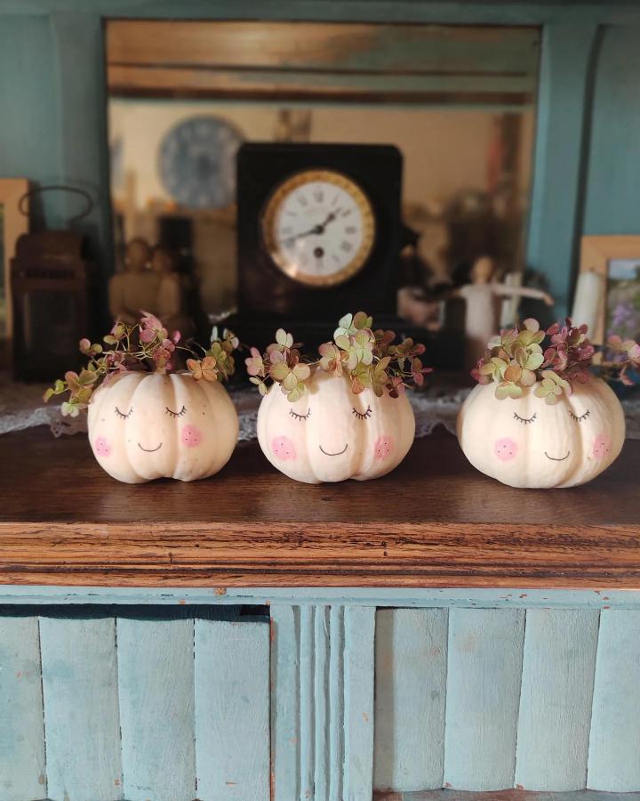 Cream pumpkin crafts for thanksgiving from @melimelodesptitsblanpain featuring painted faces and dried hydrangea crowns.