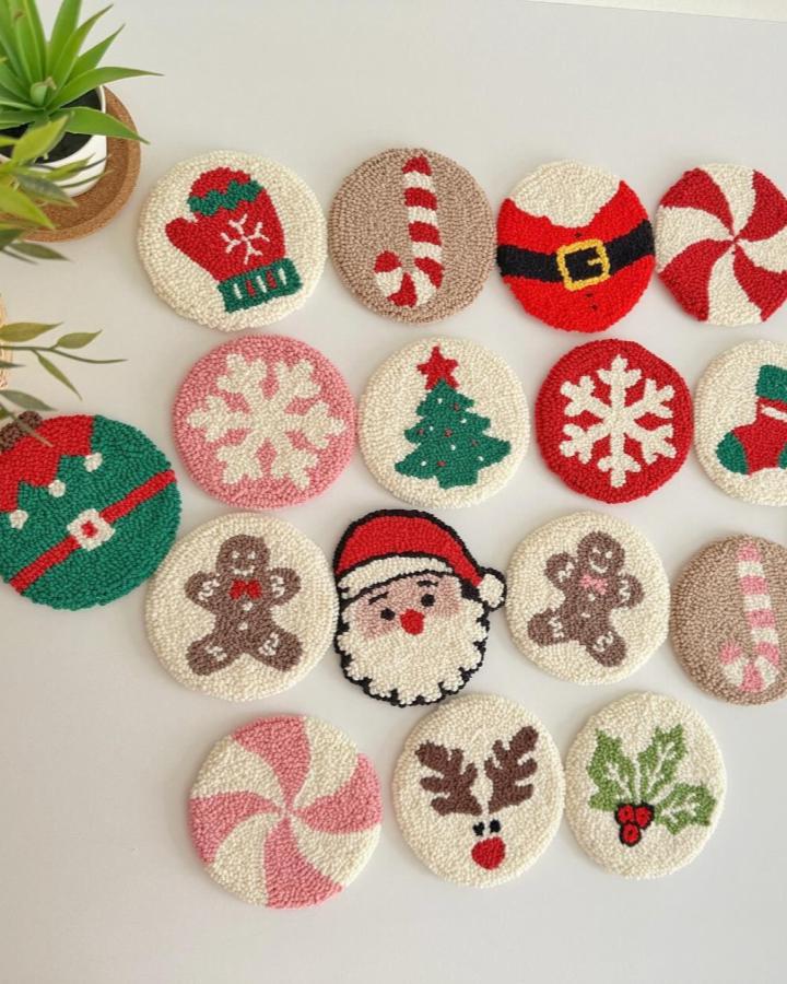 Festive circular coasters from @heipunchneedle featuring Santa, snowflakes, candy canes, and gingerbread designs in holiday colors
