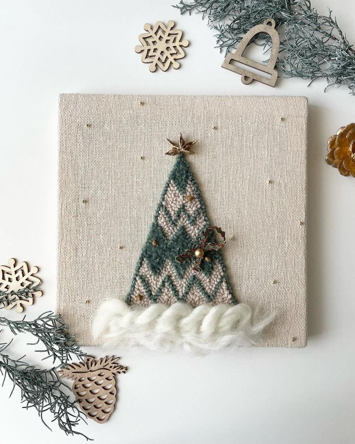 Teal chevron tree wall art from @___g.studio___ with fluffy white yarn snow base and bronze bells.