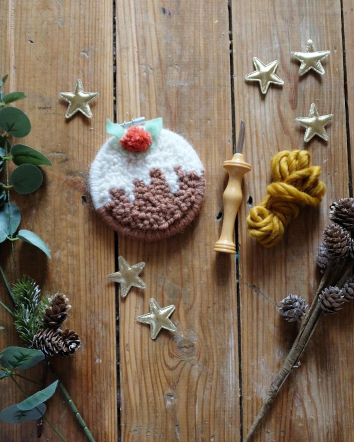 Circular textured wool ornament from @lucyrowanweaving featuring layered pudding design with coral berry accent