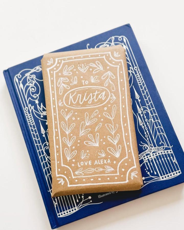 Hand drawn botanical border gift wrap from @pippipost.shop showcasing brown paper christmas wrapping ideas with white ink details.