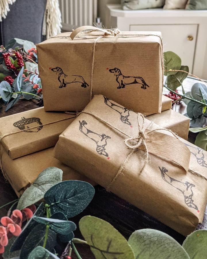 Hand-stamped kraft paper gift wrap from @dustanddaydreaming featuring dachshund illustrations and natural twine.