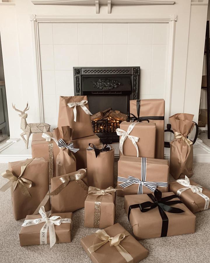 Brown paper gifts with varied ribbon styles from @making_a_home_. Fireplace display with metallic and striped accents.