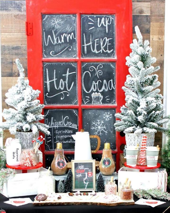 Red chalkboard window frame with flocked trees from @sugarpartiesla. Rustic cocoa station display.