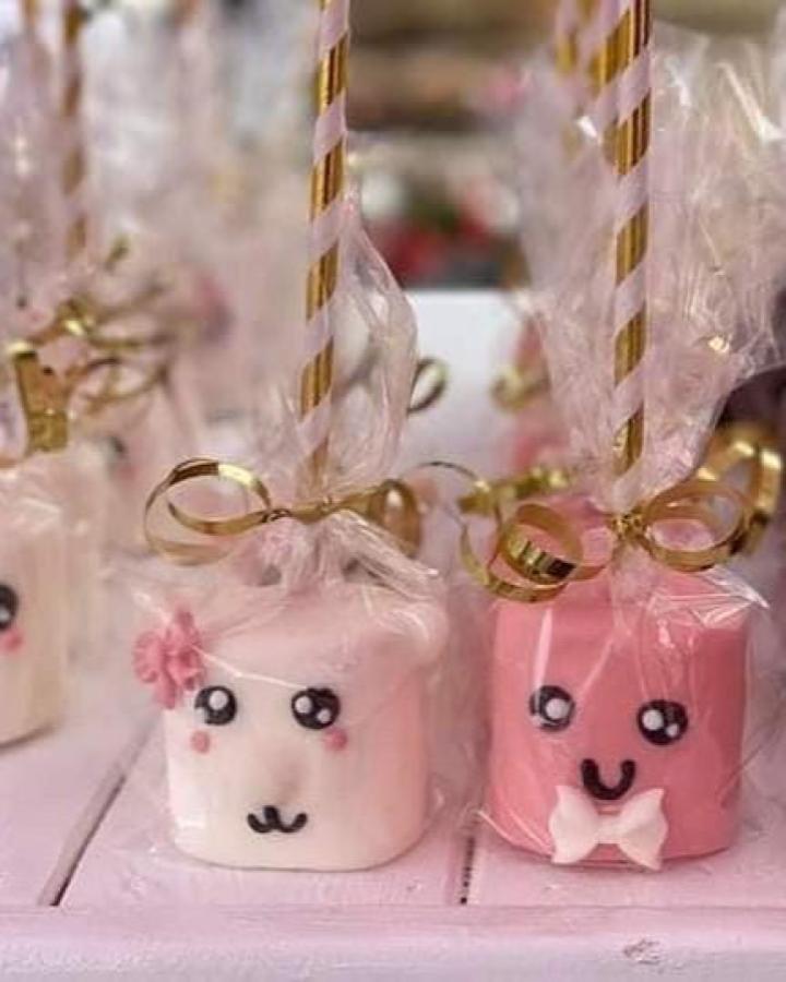 Pink and white ceramic marshmallow mugs from @sugga.shack wrapped in organza with gold bow accents.
