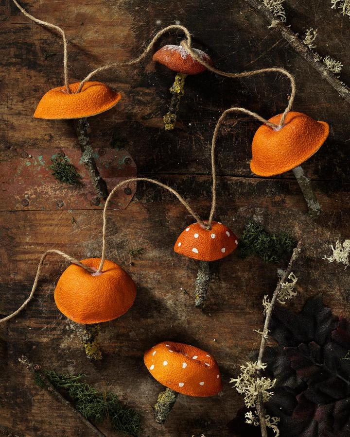 Orange peel mushroom ornaments from @panduroofficial with white painted dots and jute string hangers.