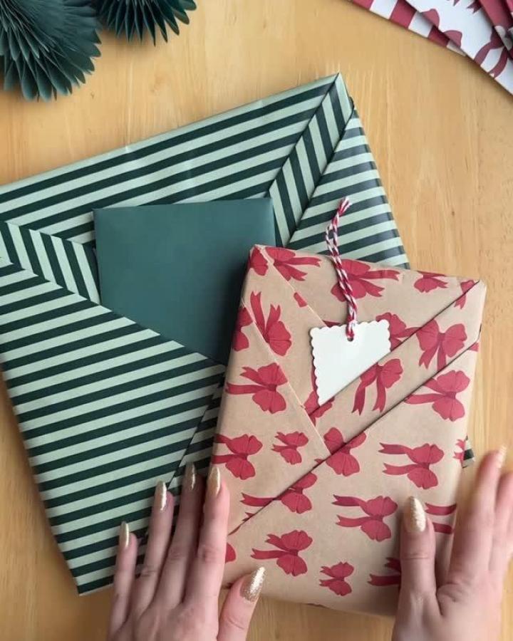Striped green and cream wrapping paper with pink bow-patterned kraft gift from @kira_goode. Candy cane twine detail.