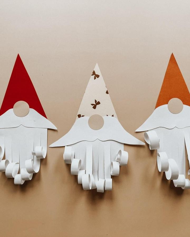 Paper gnome craft from @fraeullein_jasmin featuring red, white, and orange cardstock hats with curled beards