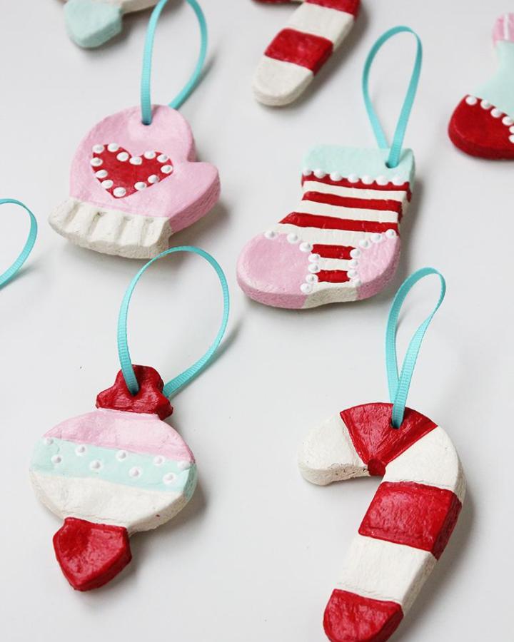 Hand-painted salt dough ornaments from Positively Splendid featuring candy canes, stockings, and mittens with turquoise ribbons.