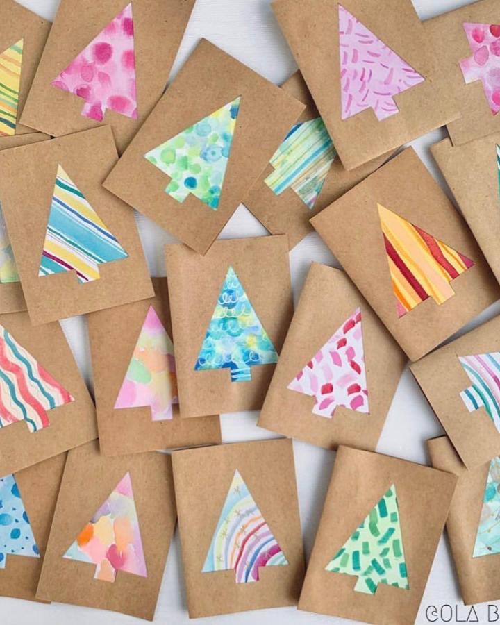 Colorful patterned paper Christmas tree cards from @recyclemeplay scattered on white surface showing various designs