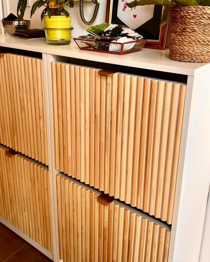 Natural pine wood paneled cabinet with white frame and leather pulls from @ikeabesthome showing ikea bissa hacks & ideas.