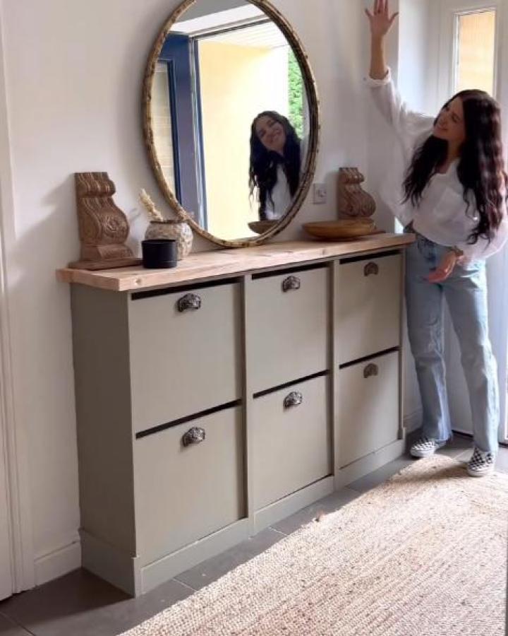 Olive-green painted Ikea Bissa cabinet with wood top and vintage handles, hallway storage from @petitelivingalmere.