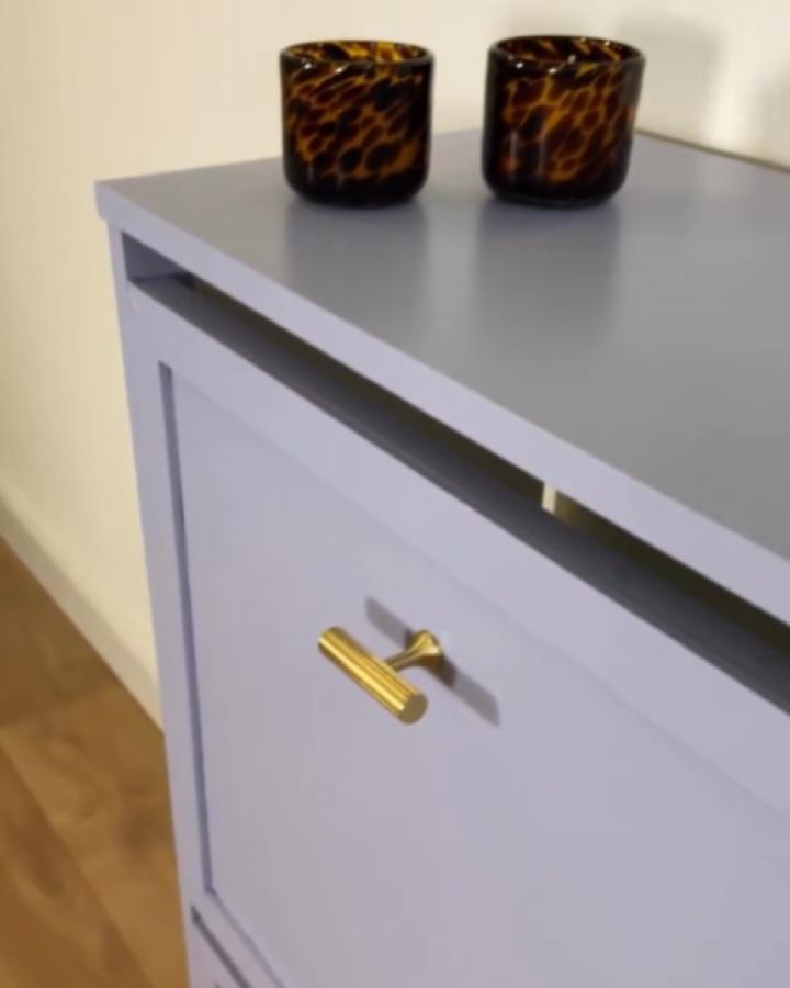 Lilac painted Ikea Bissa with gold handle and two amber glass tealight holders on top from @thestanleydiary showing ikea bissa hacks & ideas.