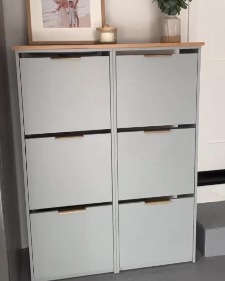 Light gray Ikea Bissa shoe cabinet with brass handles and wood top from @natalieatnumber8 showing elegant ikea bissa hacks & ideas.