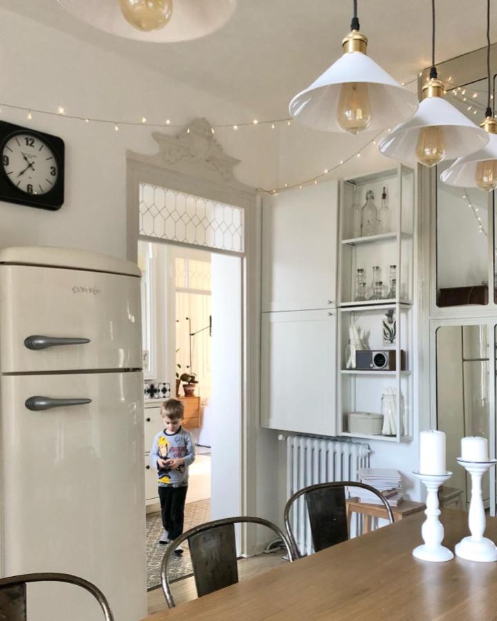 cream white kitchen storage with glass doors from @la_fargeseraie_renovee showing ikea enhet ideas in a cozy setting with vintage fridge and modern lighting